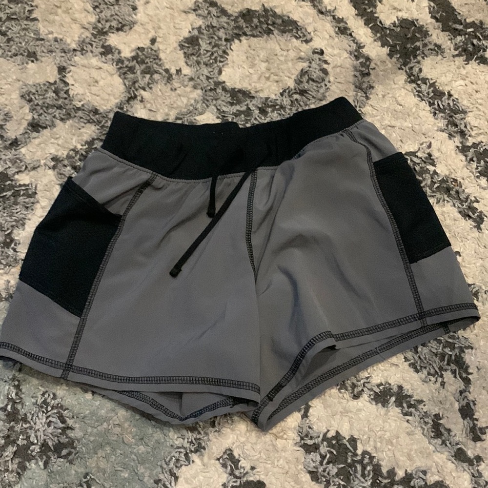 Grey and black tek gear shorts with pockets in side